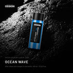 Ossion Ocean Wave After Shave bottle on wet black stone, lit from one side