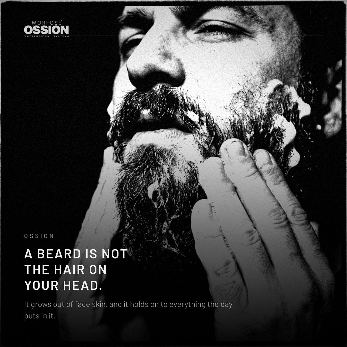A man working lather into a full beard with both hands