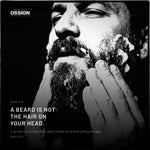 A man working lather into a full beard with both hands