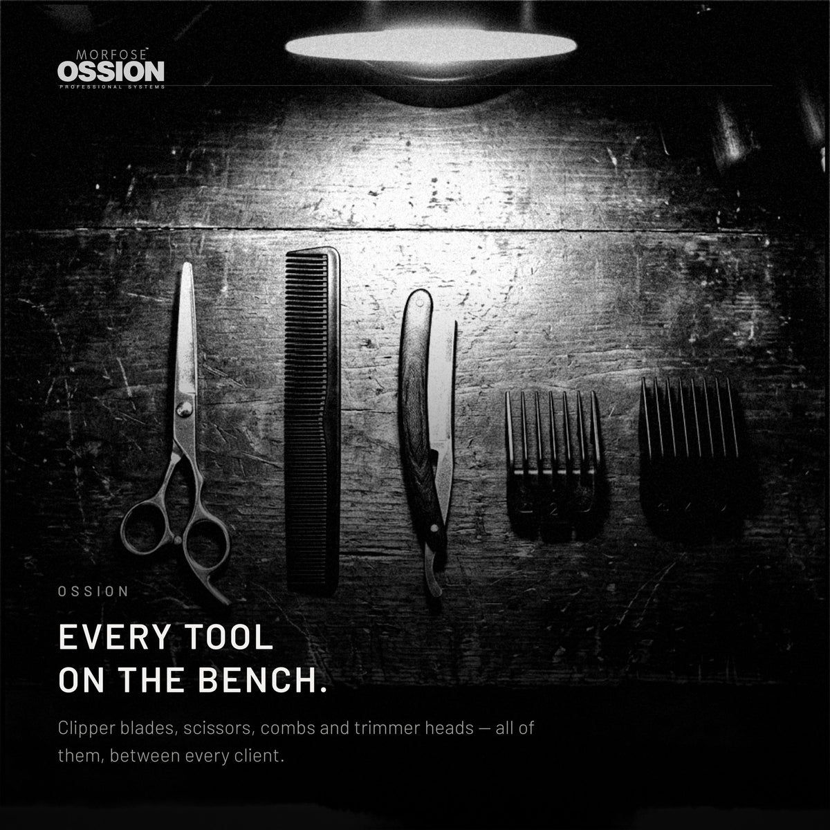Barber tools laid out in a row on a dark workbench