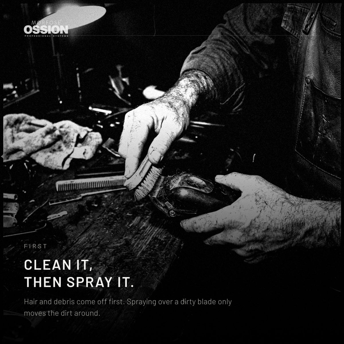 A barber clearing hair off a blade before spraying it
