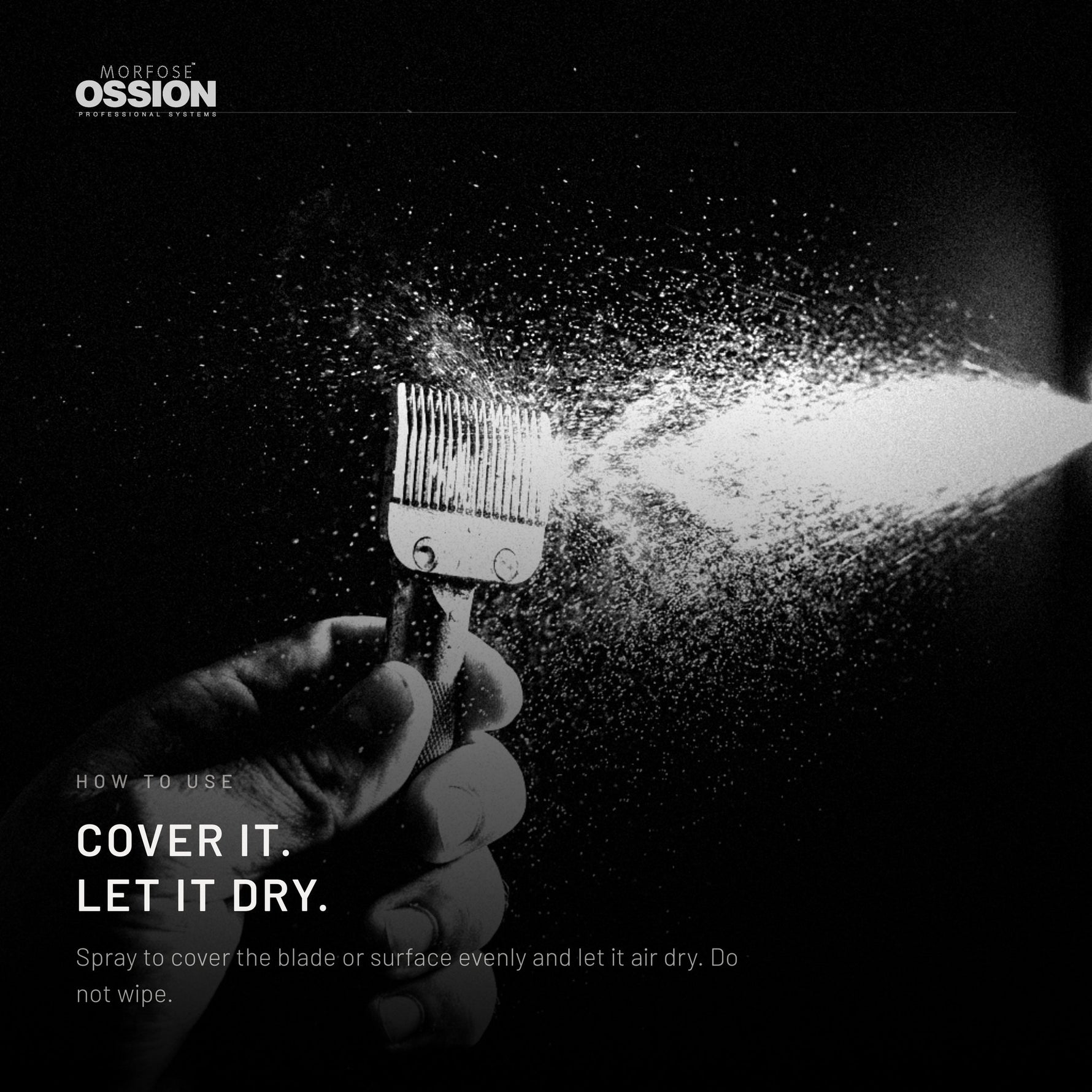 A fine spray covering a steel blade held in a hand