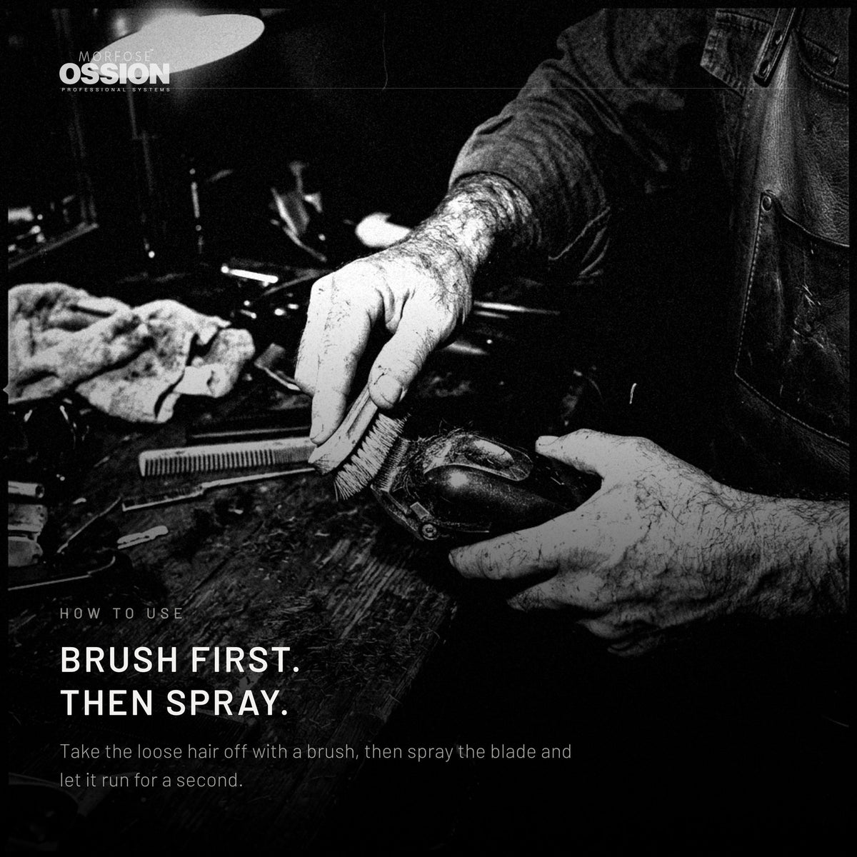 A barber brushing debris off a clipper blade