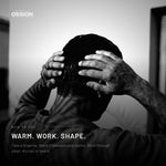 Hands warming Ossion Beard & Hair Cream before working it through dry hair