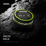Ossion Matte Hold Wax tin on wet black stone, lit from one side