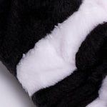 Close-up of the plush cow-print fleece pile on the Morfose spa headband