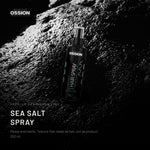 Ossion Sea Salt Spray bottle on wet black stone, lit from one side