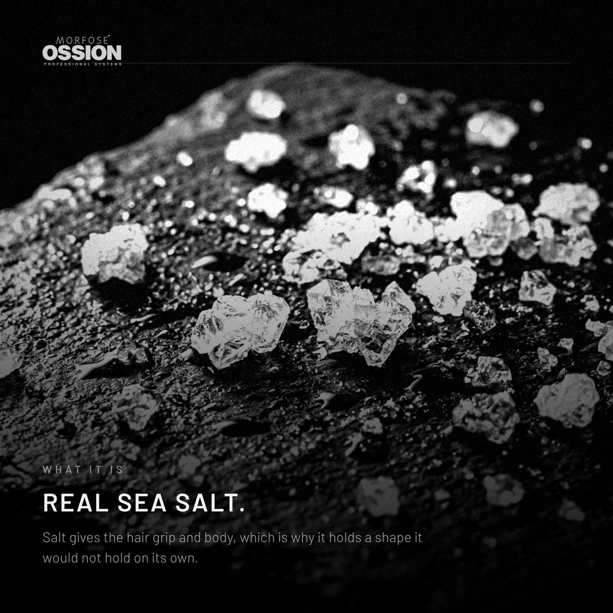 Coarse sea salt crystals on wet dark stone